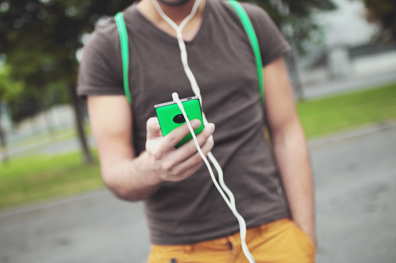 man walking and looking at phone
